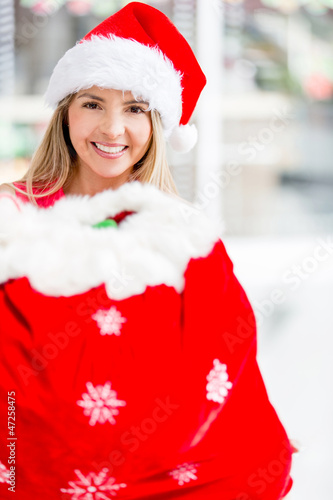 Photo: Female Santa with a gift sack Female Santa with a gift sack