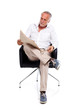 Casual senior man with newspaper, amused