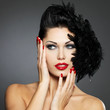 Woman with red nails and creative hairstyle