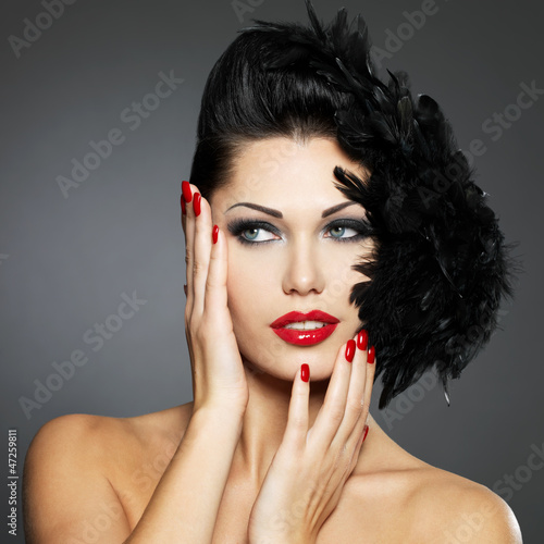 Photo: Woman with red nails and creative hairstyle Woman with red nails and creative hairstyle