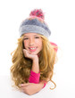 Kid girl with winter wool cap smiling on white
