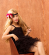 blond fashin kid girl sitting on retro vintage seat