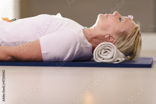 Photo: Senior woman relaxing and doing therapy with crystals Senior woman relaxing and doing therapy with crystals