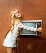 Blond vintage 70s kid girl with retro love old tv