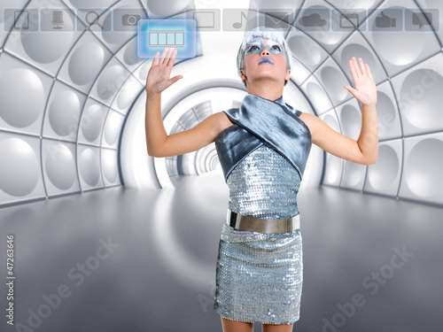 Photo: futuristic kid girl in silver touching finger icons futuristic kid girl in silver touching finger icons