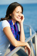 Hispanic Woman Looking Over Railing At Sea