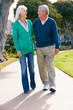 Senior Couple Walking In Park Together