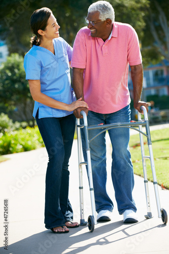 Photo: Carer Helping Senior Man With Walking Frame Carer Helping Senior Man With Walking Frame