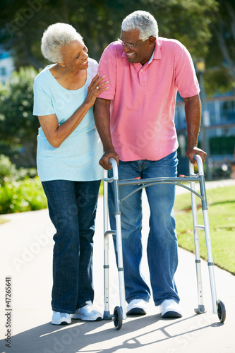 Photo: Senior Woman Helping Husband With Walking Frame Senior Woman Helping Husband With Walking Frame