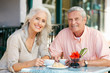 Photo: Senior Couple Enjoying Snack At Outdoor Café Senior Couple Enjoying Snack At Outdoor Café