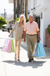 Photo: Senior Couple Carrying Shopping Bags Senior Couple Carrying Shopping Bags