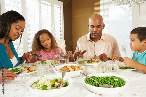 Photo: Family Enjoying Meal At Home Family Enjoying Meal At Home