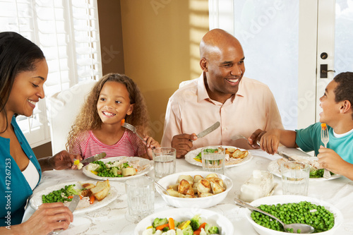 Photo: Family Enjoying Meal At Home Family Enjoying Meal At Home