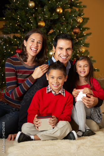 Photo: Family In Front Of Christmas Tree Family In Front Of Christmas Tree