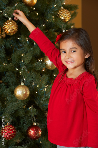 Photo: Girl Decorating Christmas Tree Girl Decorating Christmas Tree
