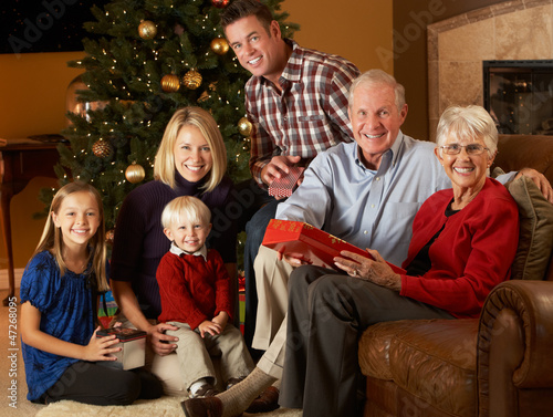 Photo: Multi Generation Family Opening Christmas Presents In Front Of T Multi Generation Family Opening Christmas Presents In Front Of T