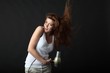young beauty with hairdryer and flying hair
