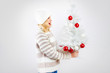 beautiful blonde woman holding a christmas gift is smiling