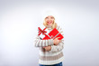 beautiful blonde woman holding a christmas gift is smiling