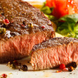 Grilled steaks, French fries and vegetables