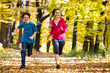 Girl and boy running, jumping in park