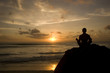 Photo: Shilouette of man meditating on the beach Shilouette of man meditating on the beach