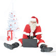 Photo: Weihnachtsmann arbeitet am Laptop Weihnachtsmann arbeitet am Laptop
