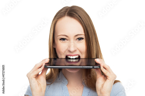 Photo: Woman with digital tablet in mouth Woman with digital tablet in mouth