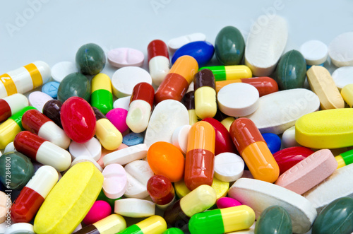 Photo: Pile of pills in medicine container Pile of pills in medicine container