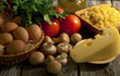 Composition of pasta, tomatoes, cheese, olive oil and mushrooms.