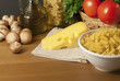 Composition of pasta, tomatoes, cheese, olive oil and mushrooms.