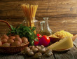 Composition of pasta, tomatoes, cheese, olive oil and mushrooms.