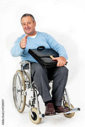 Photo: Friendly man in wheelchair holding thumbs up Friendly man in wheelchair holding thumbs up