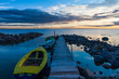 Peaceful sea sunset and pier boats