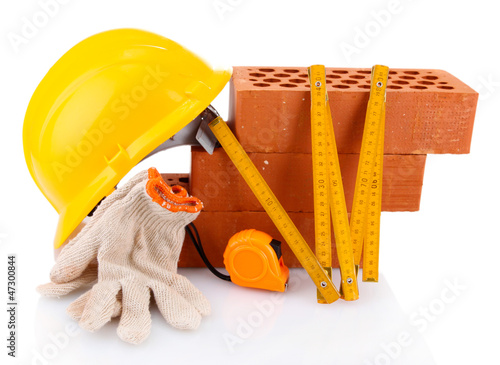 Photo: helmet, roulette, bricks and gloves isolated on white helmet, roulette, bricks and gloves isolated on white