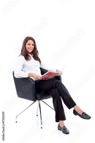 Photo: Casual 20s women sitting with newspaper Casual 20s women sitting with newspaper