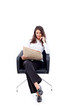 Casual 20s woman reading stock rates in newspaper