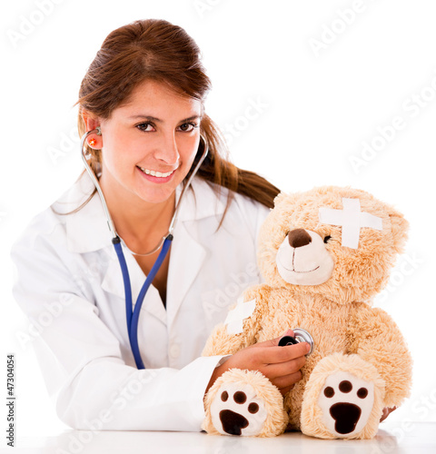 Photo: Doctor fixing a sick teddy bear Doctor fixing a sick teddy bear