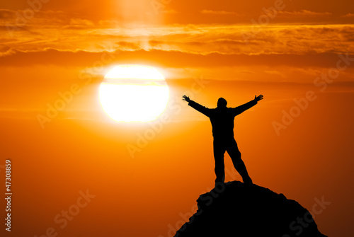 Photo: Man on peak of mountain. Man on peak of mountain.