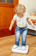 Boy is checking his weight.