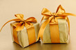 Photo: Two golden wrapped gift boxes Two golden wrapped gift boxes