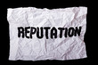 Wrinkled sheet of paper with inscription "Reputation"