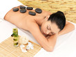 Stone massage for woman at  spa salon.