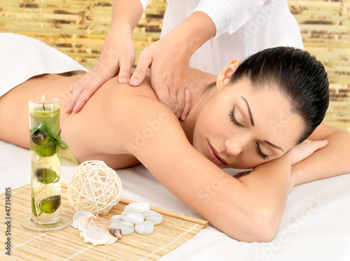 Photo: Woman having massage of body in spa salon Woman having massage of body in spa salon