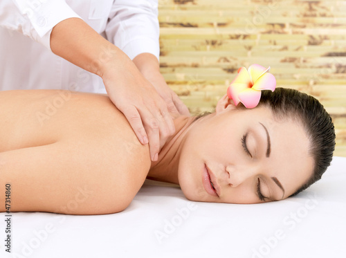 Photo: Woman having massage of head in spa salon Woman having massage of head in spa salon