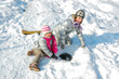 Kids having fun in winter, children playing with snow