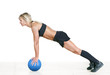 strong woman doing push-up on a ball