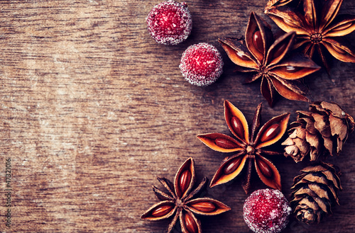Photo: Rustic christmas background with star anise Rustic christmas background with star anise