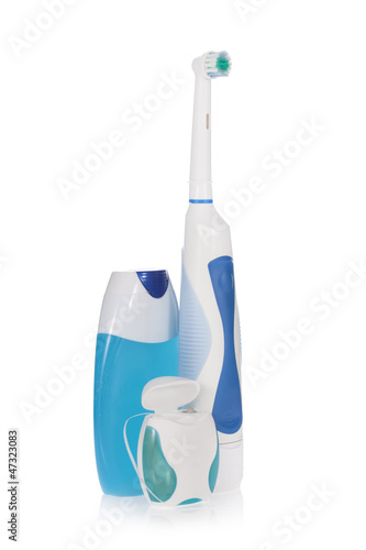 Photo: Electric toothbrush, toothpaste and dental floss isolated Electric toothbrush, toothpaste and dental floss isolated