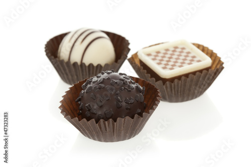Photo: Gourmet chocolate bonbons isolated on white background. Gourmet chocolate bonbons isolated on white background.